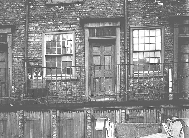 Terraced house in York slum area of Hungate with shared water-pump and shared toilets in the street below