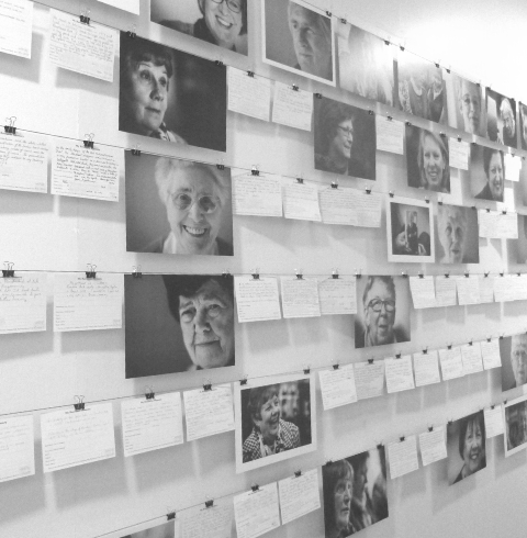 photographs of older people and postcards with memories on gallery wall