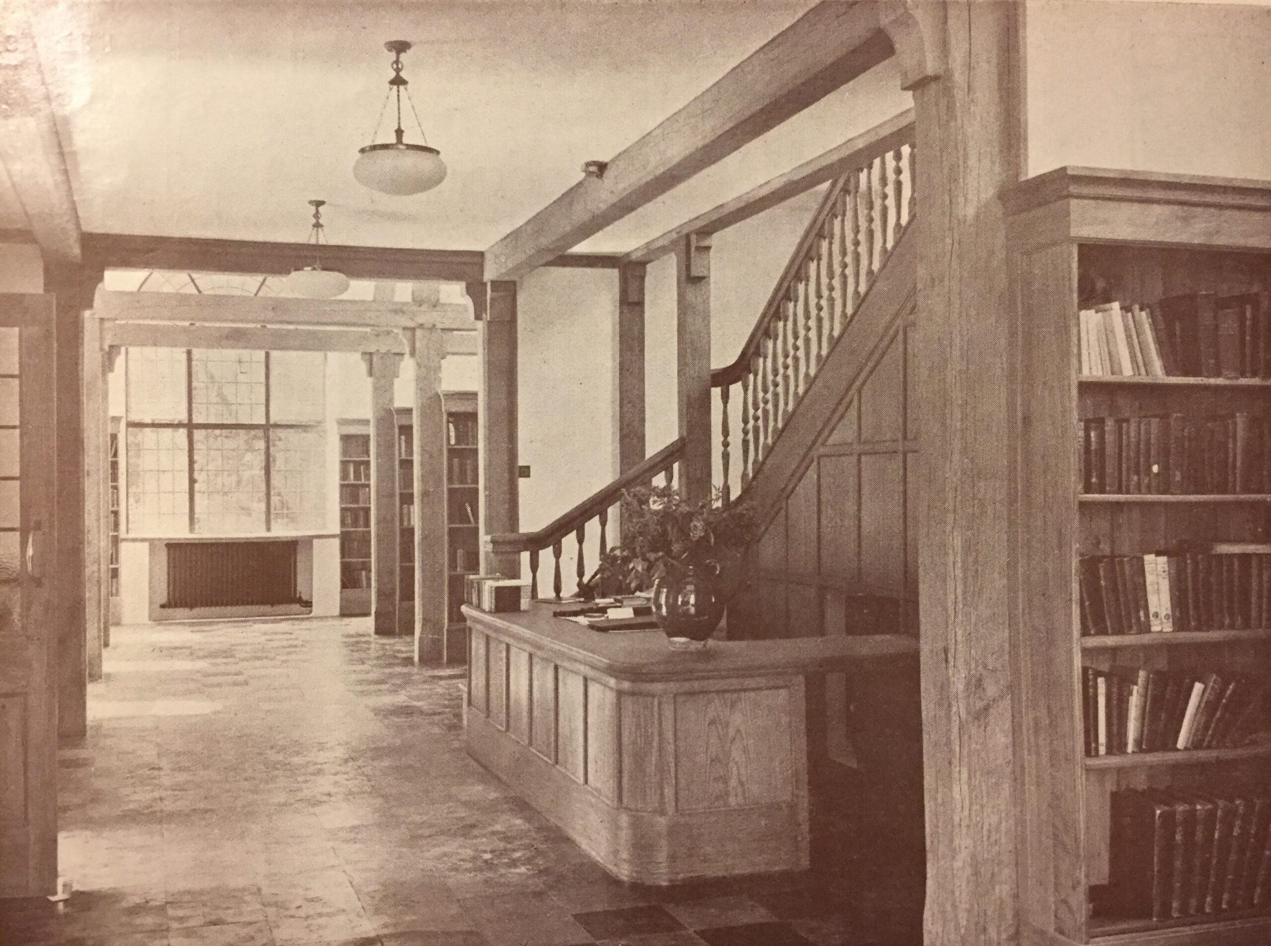 Interior of JR Memorial Library. Reception desk with wooden fixtures and furnishings in the Arts and Crafts tradition.